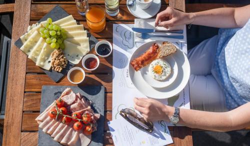 a wooden table with plates of food on it at Hotel Residenz Hochalm - Joker Card Partner in Saalbach Hinterglemm