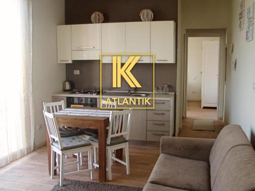 a kitchen with a table and a stove and a couch at KatlantiK Ca Madeira Deluxe in Sal Rei