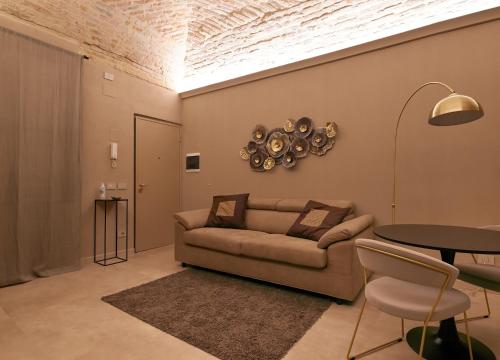 a living room with a couch and a table at Parma Centro House in Parma