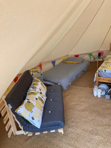 a room with two beds in a tent at Dyfi Dens Machynlleth in Esgair-geiliog