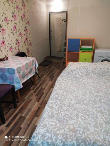 a room with two beds and a table and a door at Апартаменты на Пушкина, 13 in Perm