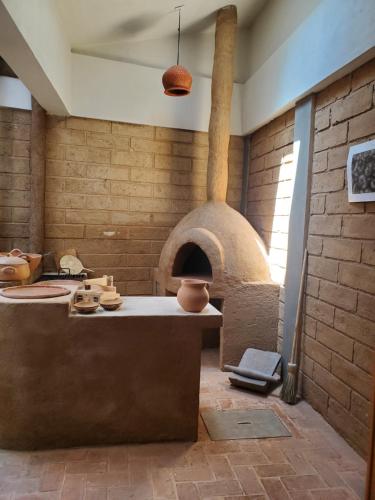 a kitchen with a pizza oven in a room at Casa Carmen in San Cristóbal de Las Casas
