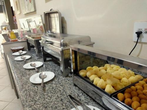 a kitchen with a bunch of food on a counter at Hotel Santiago in Lindóia