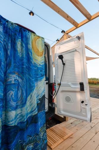 a camper van with its door open on a deck at Van Gogh in San Juan