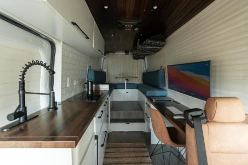 an rv kitchen with a sink and a desk at Van Gogh in San Juan