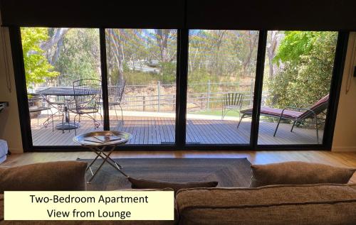 a living room with a view of a patio at Adelphi Apartments 3 or 3A - Downstairs 2 Bedroom or Upstairs King Studio with Balcony in Echuca