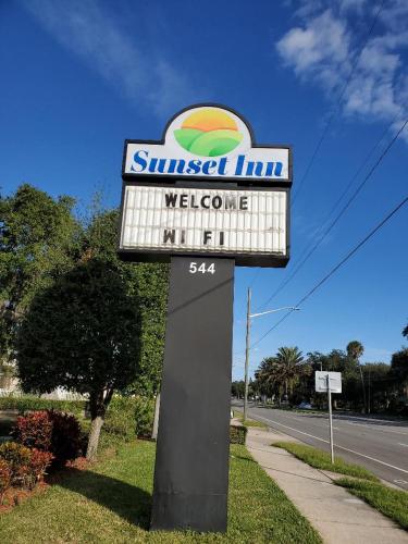 a sign for a swiss oil company on the side of a road at Sunset Inn Daytona Beach in Daytona Beach
