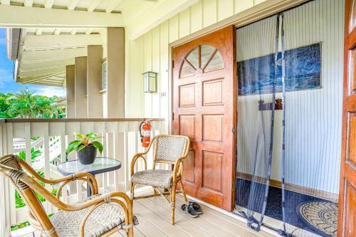 a porch with chairs and a door and a table at Paniolo #202B in Princeville