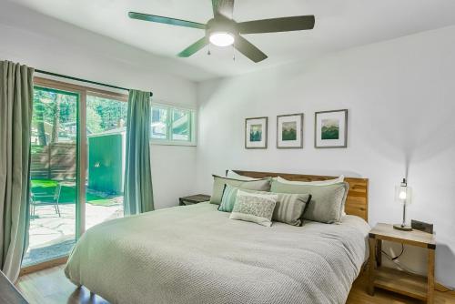 a bedroom with a bed and a ceiling fan at The Lazy Golden Cabin in South Lake Tahoe