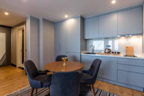 a kitchen with a table and chairs in a room at SALA SUITES in Istanbul