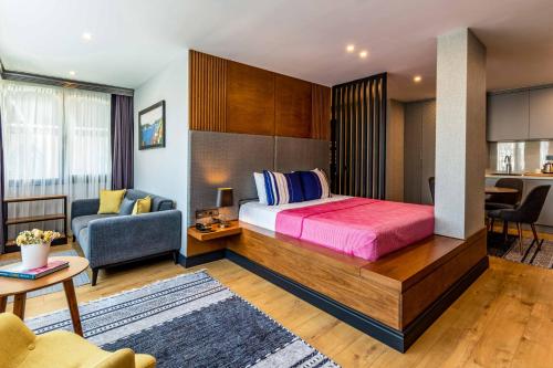 a bedroom with a large bed and a living room at SALA SUITES in Istanbul