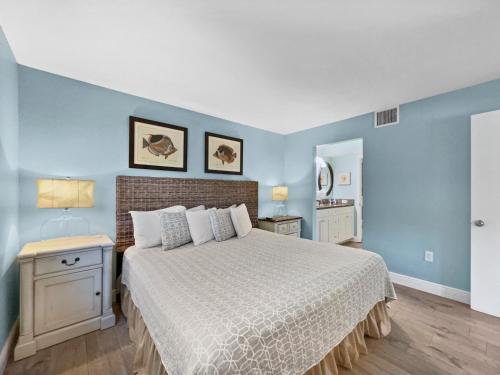 a bedroom with a bed and blue walls at Newly Fully Updated and Modern, Short Walk to BEACH in Siesta Key