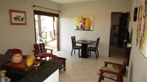 a kitchen and dining room with a table and chairs at Brisas do Amor 131 in Pipa