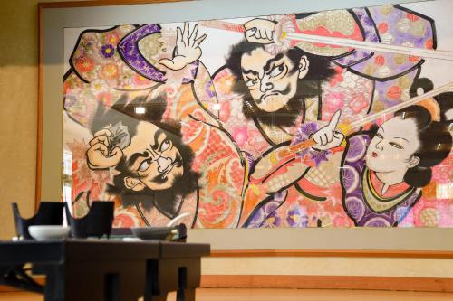 a large painting of people on a wall at Yanagi No Yu in Aomori