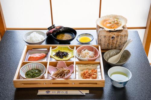 a tray filled with different types of food on a table at Yanagi No Yu in Aomori