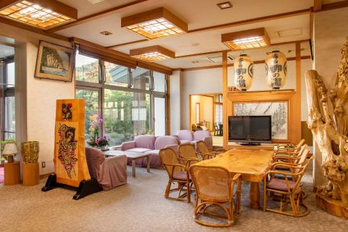 a living room with a table and chairs at Yanagi No Yu in Aomori