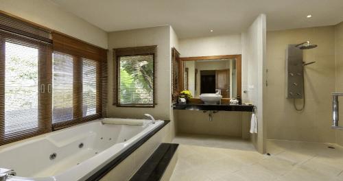 a large bathroom with a tub and a sink at Villa Yoosook in Patong Beach