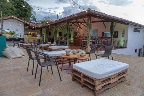 a patio with tables and chairs and a pavilion at Don Juan De Dios De Guane Hotel & Centro De Convenciones in Barichara