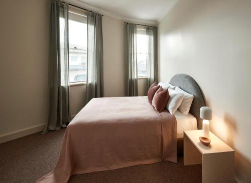 a bedroom with a bed with pillows and a window at The Rooms Milton in Milton