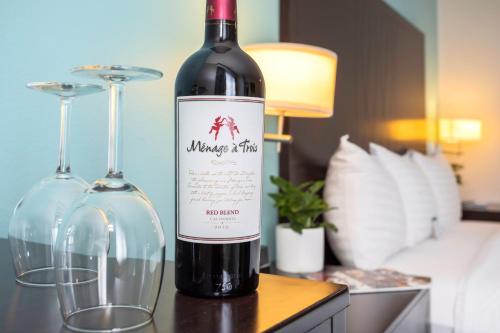 a bottle of wine on a table with two glasses at The Hotel Oceanside in Oceanside
