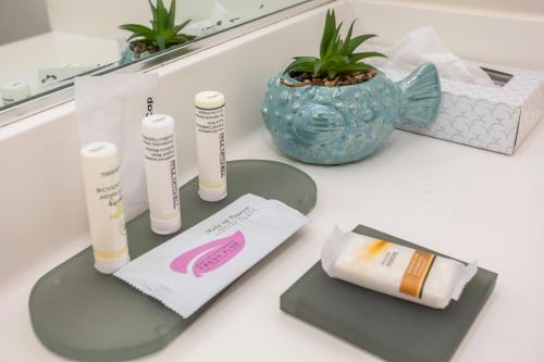 a counter withbranded products and a vase on it at The Hotel Oceanside in Oceanside