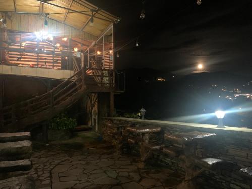 a night view of a building with a balcony at Cabinas Vista Al Golfo in Monteverde Costa Rica