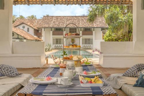 a table with food on top of a patio at The Villa Bentota by KK Collection in Bentota