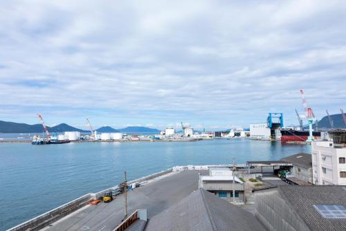 a large body of water with a dock with a ship at Hotel Vega Takamatsu (Adult Only) in Takamatsu