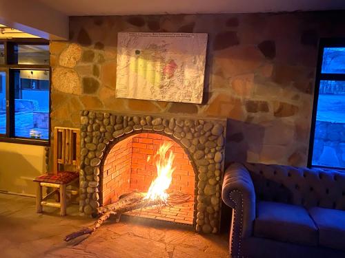a brick fireplace with a fire in it at Oldarpoi Wageni Camps in Keekorok
