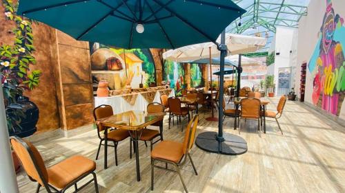 a painting of a restaurant with tables and chairs at Hotel Las Brisas Centro in La Paz