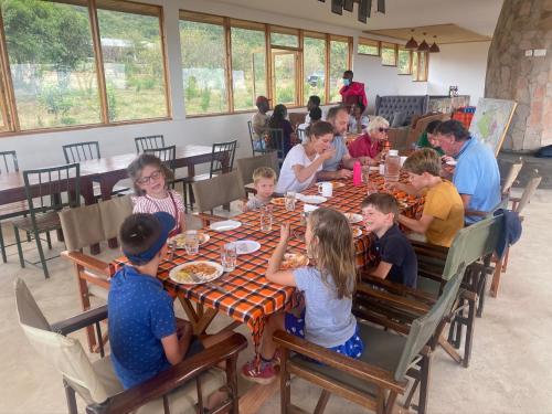 a group of children sitting at a table in a restaurant at Oldarpoi Wageni Camps in Keekorok