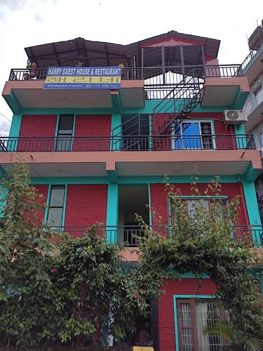 a red building with a sign on it at Harry Guest House & Restaurant in Pokhara