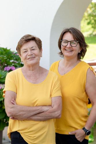 two older women standing with their arms crossed at Gästehaus Lässer in Mellau