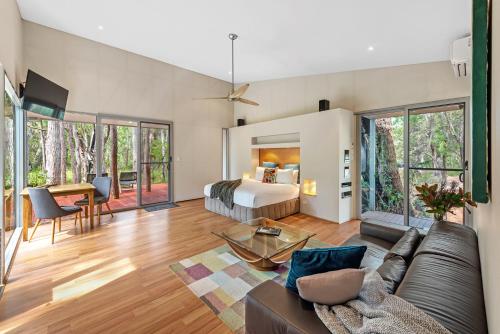 a living room with a bed and a couch at Hidden Valley Forest Retreat in Carbunup