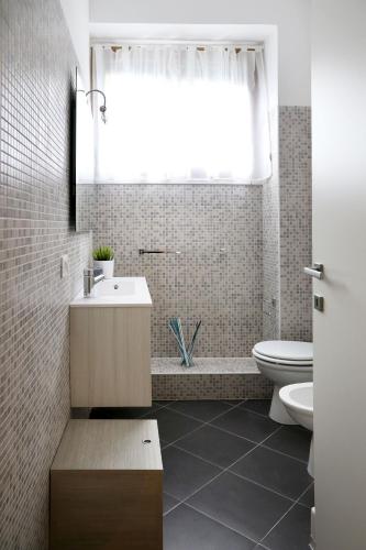 a bathroom with a sink and a toilet and a window at Guest House Roma in Rome
