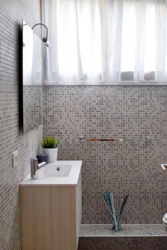 a bathroom with a sink and a mirror at Guest House Roma in Rome