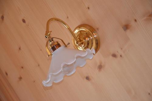a light on a wall with a white object in it at Garni Franca b&b in Selva di Val Gardena