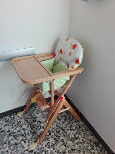 a childs high chair sitting on a high stool at Casa Vacanza Elena in San Bernardino Verbano
