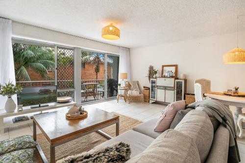 a living room with a couch and a table at Wintersview 9 - Lennox Head in Lennox Head