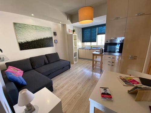 a living room with a couch and a kitchen at Casa Vitale in Aci Castello