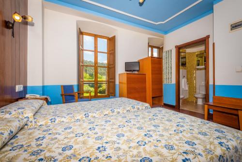 a bedroom with a bed and a window at Hotel Castillo de Gauzón in Salinas
