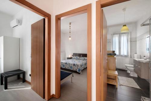 a bedroom with a bed and a bathroom at Sibi Apartment in Lierna