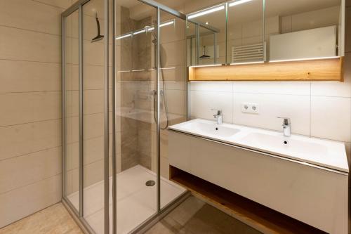 a bathroom with a sink and a shower at Gästehaus Schwaiger in Sankt Michael im Lungau
