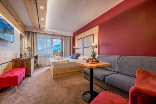 a hotel room with a bed and a couch at Penzión Šafrán in Ždiar