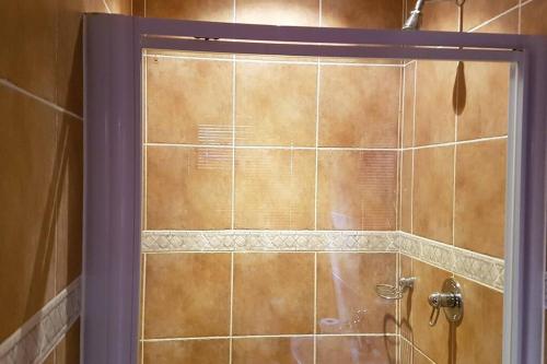 a shower with a glass door in a bathroom at Pecanwood Home Away from Home in Hartbeespoort