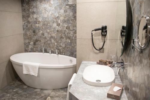 a bathroom with a tub and a toilet and a sink at Melas Hotel Istanbul in Istanbul