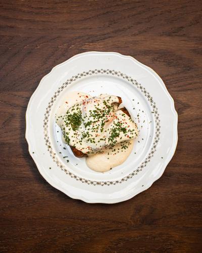 a white plate with food on a wooden table at Babel Belleville in Paris