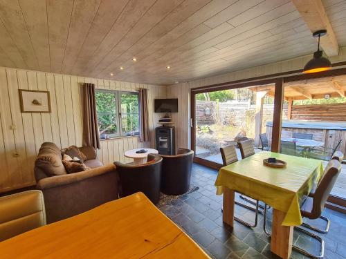 a living room with a couch and a table at Chalet Cato in Durbuy