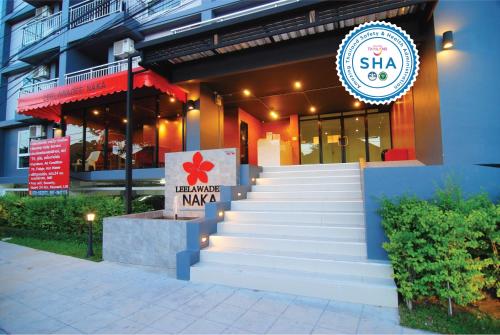 a restaurant with stairs leading up to a building at Leelawadee Naka in Phuket