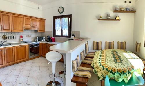a kitchen with a table in the middle of it at La Dolce Vista in Tremezzo